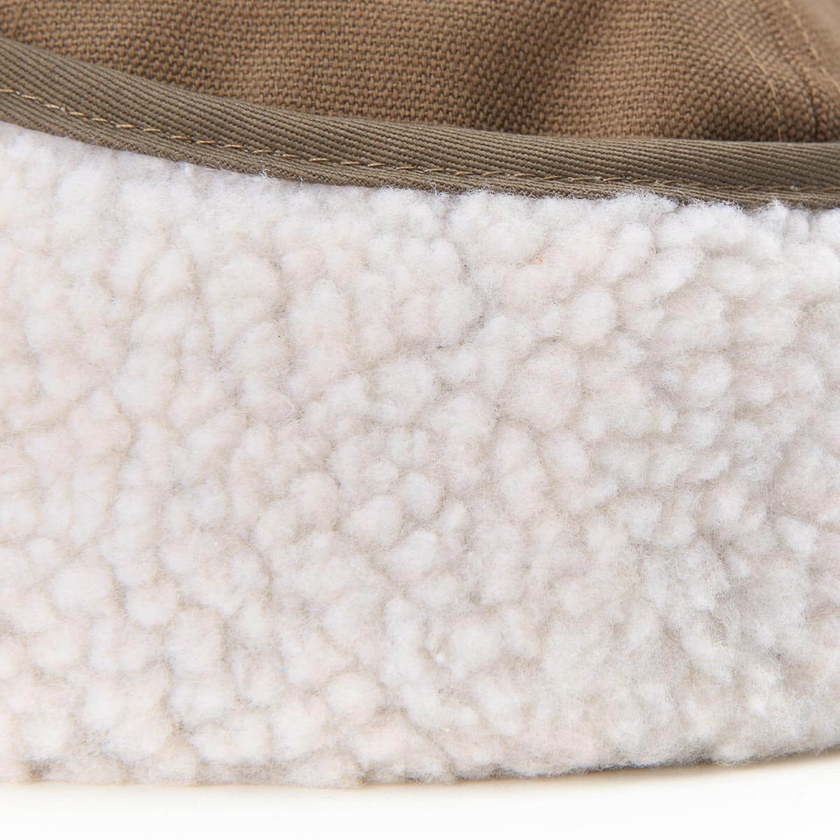 Close-up of a textured fabric with a brown border on a white background